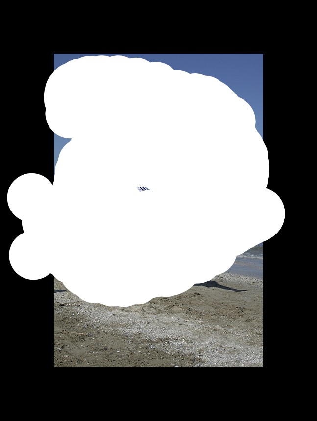 In the image in the center we can see one person holding some object. In the background there is a sky and water.