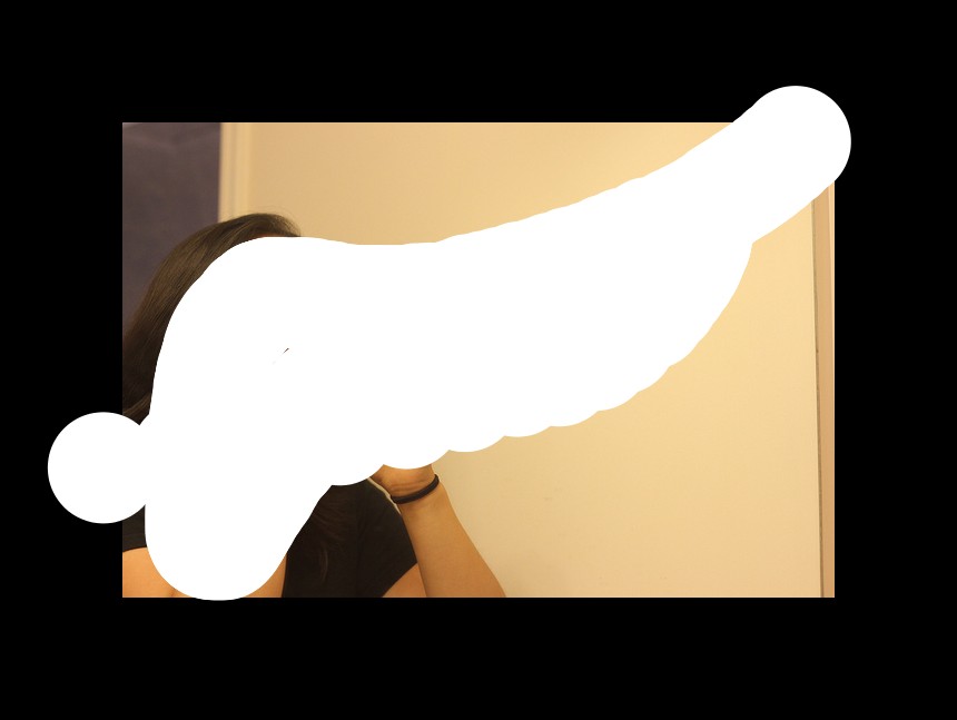 In this image we can see a woman is standing and brushing the teeth. Here is the wall.