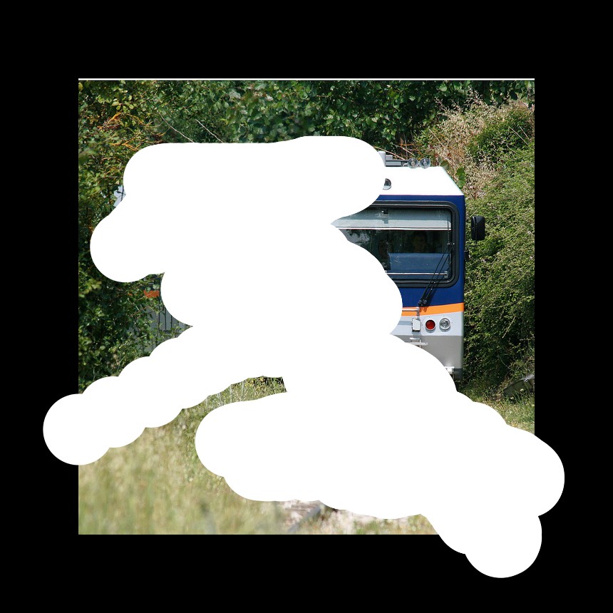 A train is passing by some trees. The train is in silver with blue and a orange line painted on it. It is electric locomotive. The railway gauge is narrow. There are plants and grass on either side of the track.