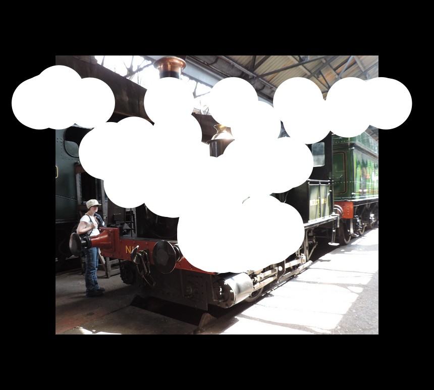 In the picture we can see a train engine, near to that we can see a woman standing with shoes, bag, cap and white T-shirt, the engine is placed under the shed and near to it there is stand and the train.