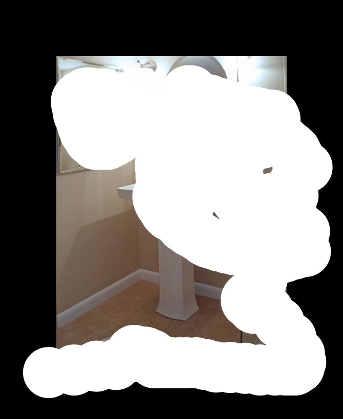 In this picture we can see a shower room, in the middle there is a wash basin, on the top of washbasin we can see a mirror, on the right side image there is a towel, on the left side of image we can see another mirror, we can see a glass here and a mat on the bottom.